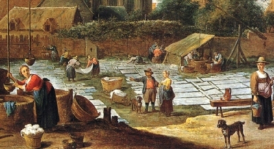 villagers washing and spreading white linen on the grass